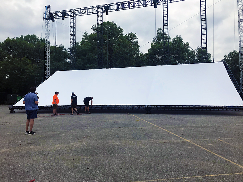 Screen being raised for the Rooftop Films pop-up outdoor theater in Queens, NY.